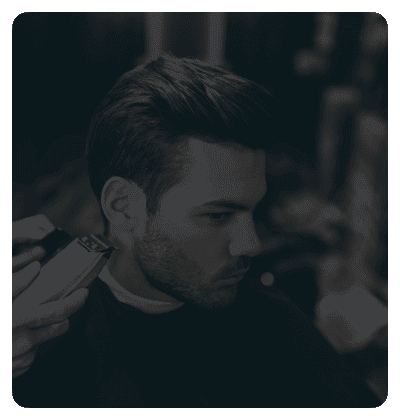 Man receiving a professional haircut at a barber shop.