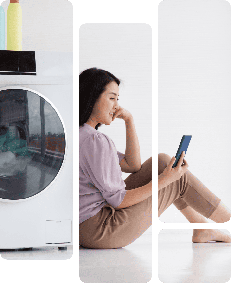 Woman using smartphone near washing machine.